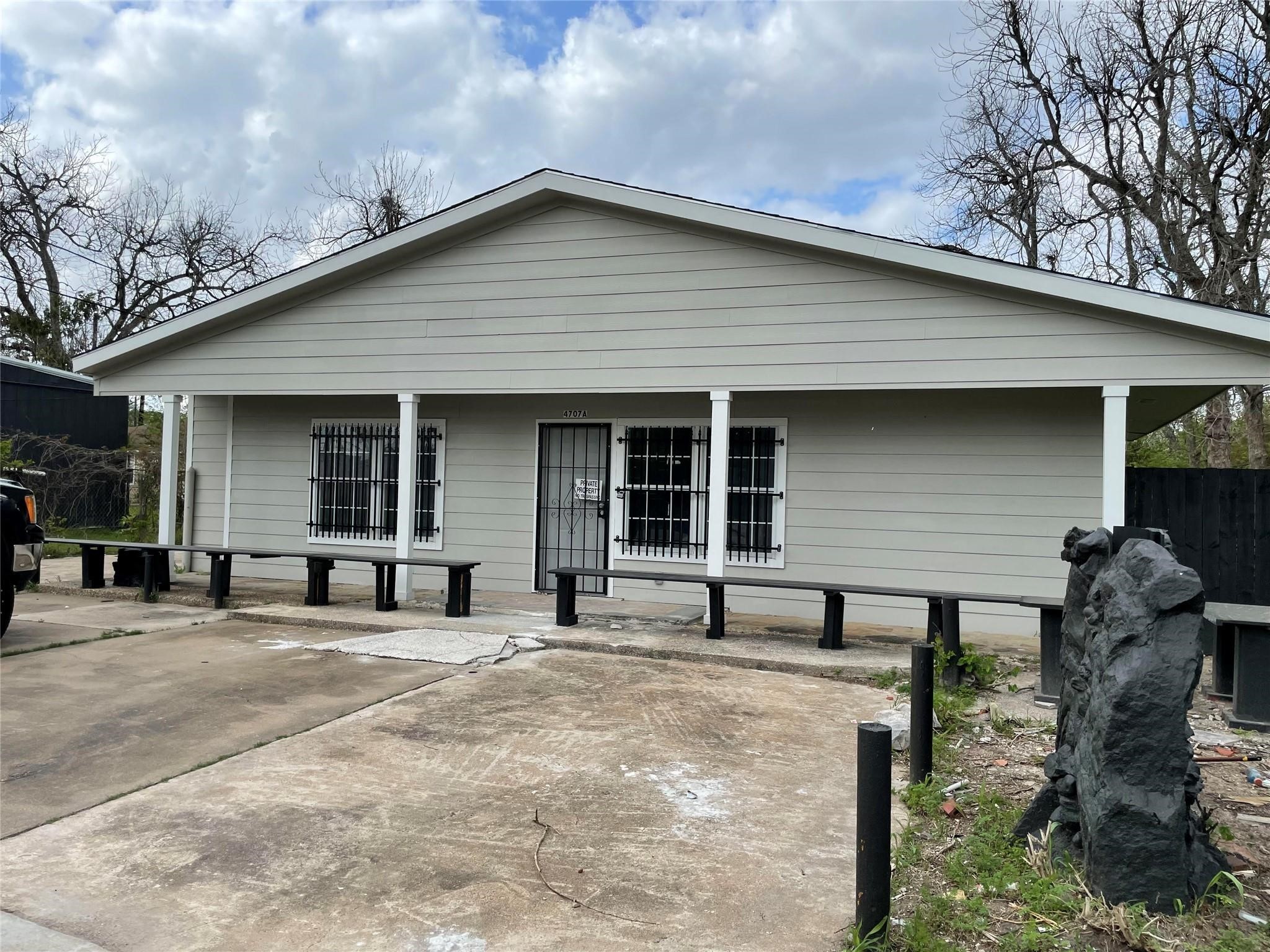 4707 Mallow Street, Unit B Houston, TX 77033 - Photo 1 of 16 a front view of a house with large garden and chairs