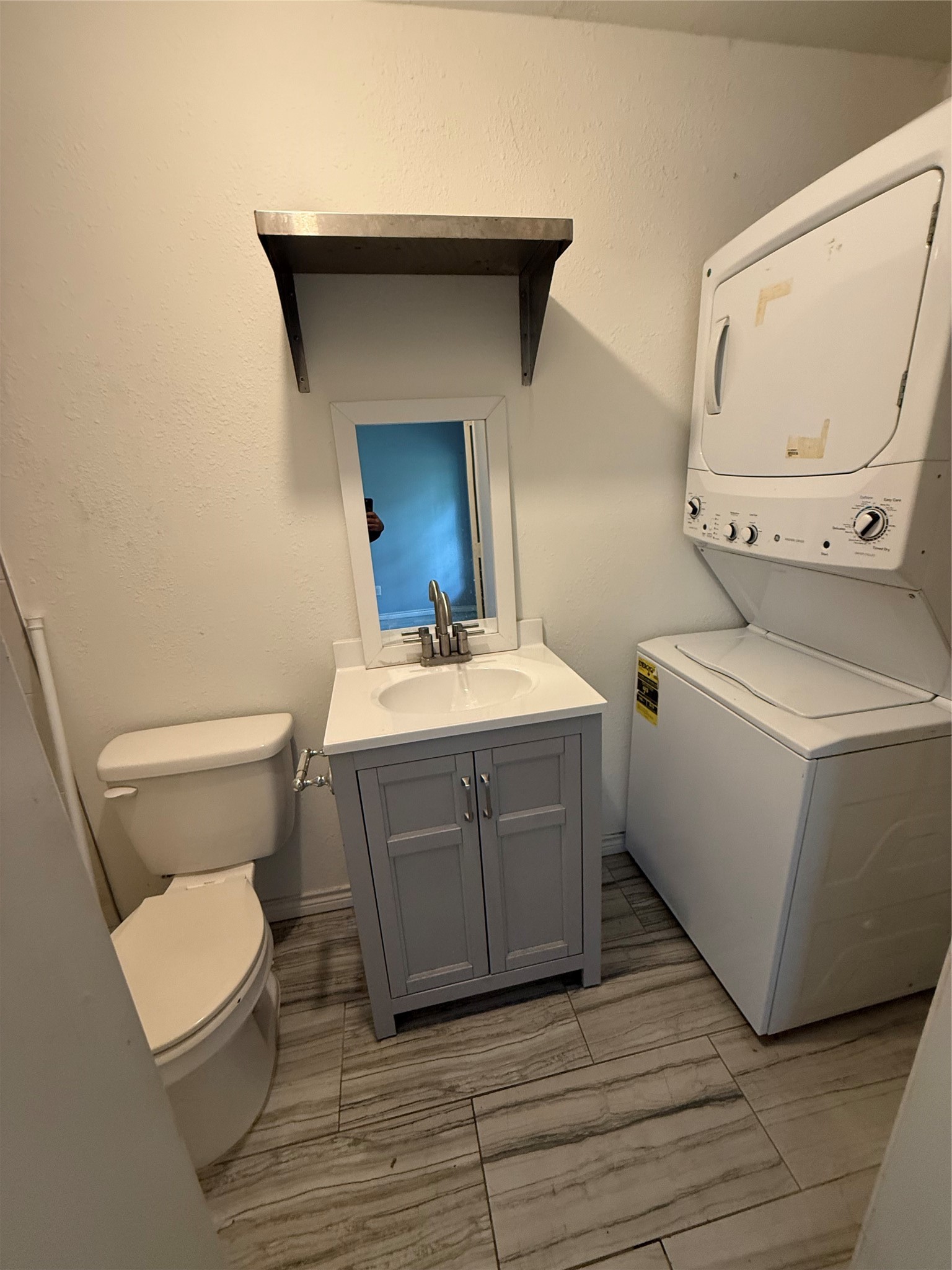 4707 Mallow Street, Unit B Houston, TX 77033 - Photo 11 of 16 a bathroom with a toilet a sink and a mirror