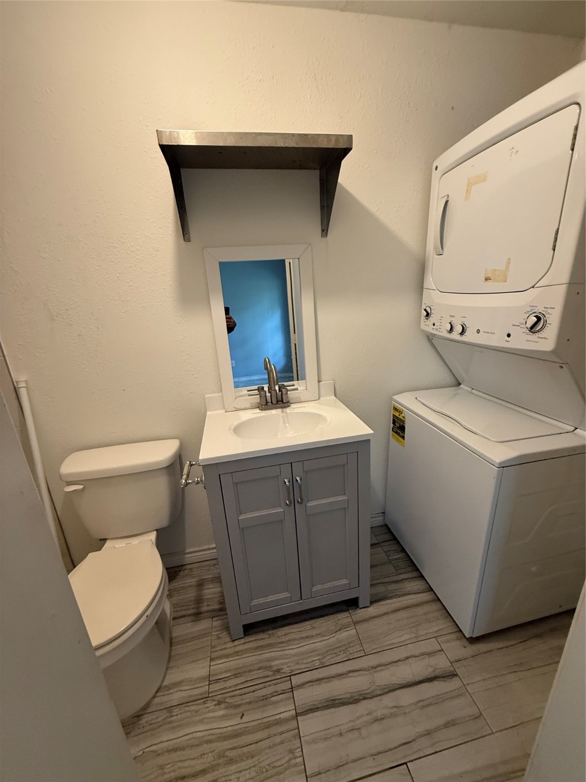 4707 Mallow Street, Unit B Houston, TX 77033 - Photo 11 of 16 a bathroom with a toilet a sink and a mirror