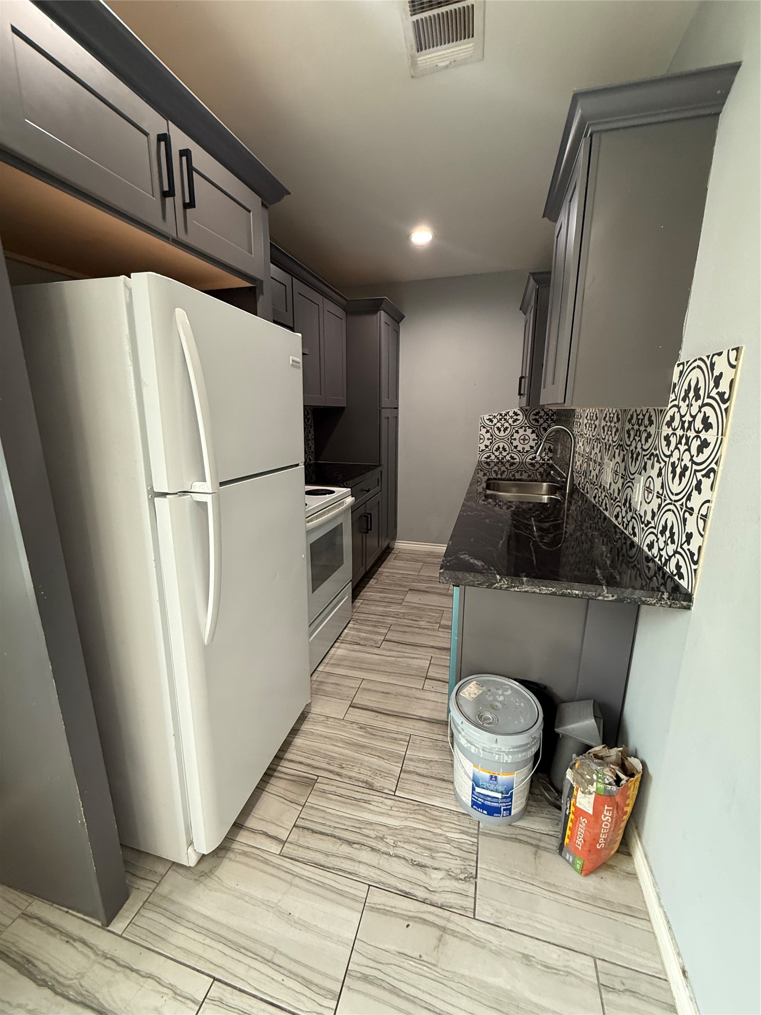 4707 Mallow Street, Unit B Houston, TX 77033 - Photo 12 of 16 a refrigerator freezer sitting inside of a kitchen