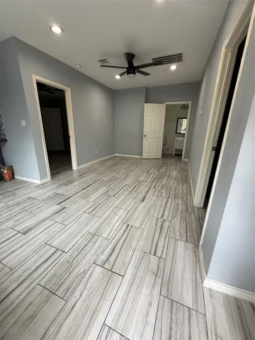 a view of a room with wooden floor and staircase