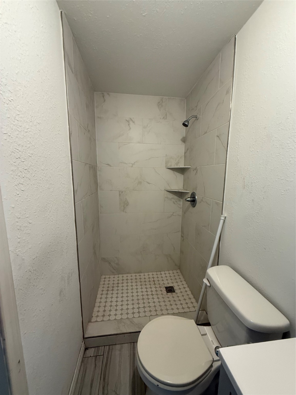4707 Mallow Street, Unit B Houston, TX 77033 - Photo 9 of 16 a white toilet sitting next to a shower