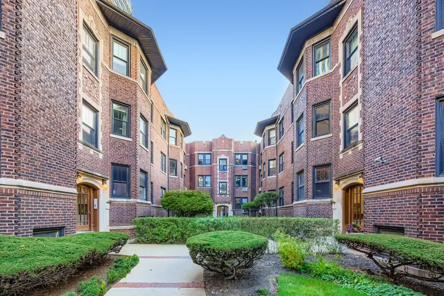 a view of a building next to a yard