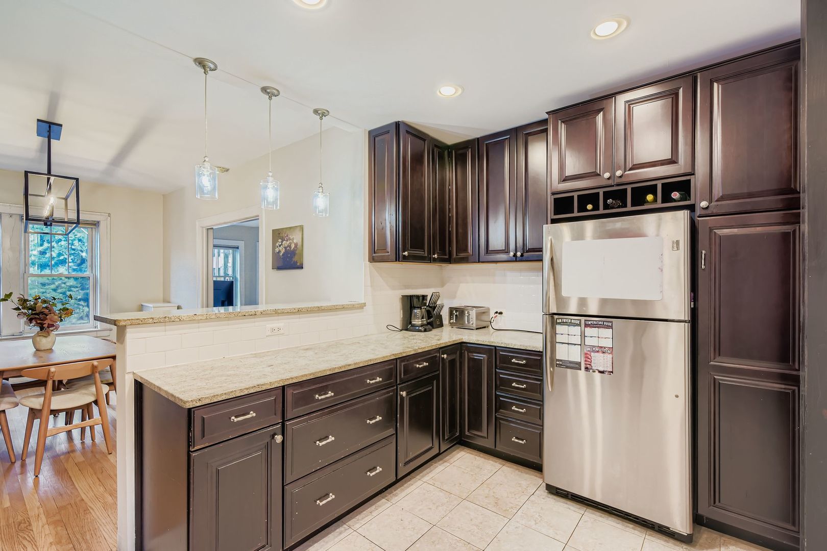 539 West Addison Street, Unit 2N Chicago, IL 60613 - Photo 16 of 23 a kitchen with granite countertop stainless steel appliances and refrigerator