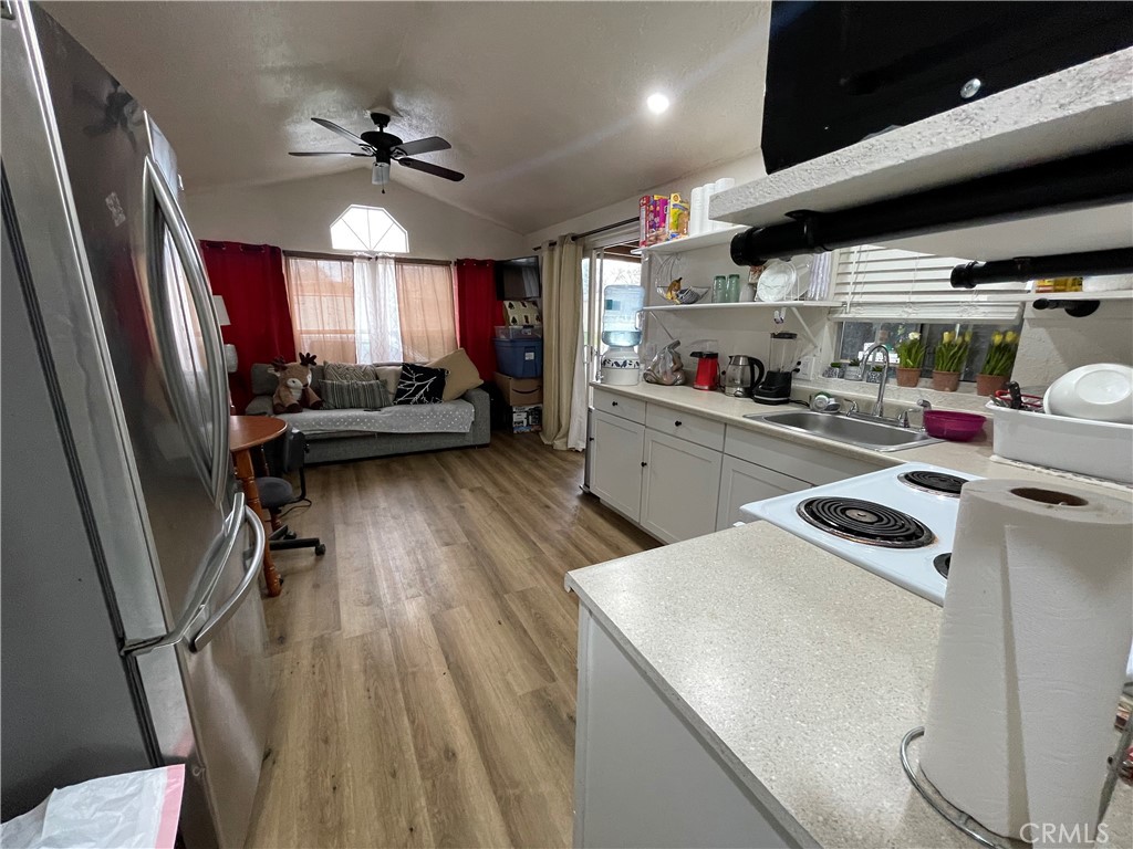 a kitchen that has a sink a microwave and a stove