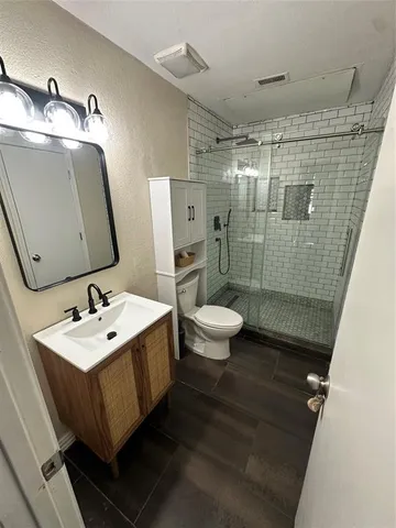 a bathroom with a sink mirror toilet and shower