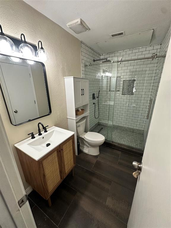 5616 Preston Oaks Road, Unit 1605 Dallas, TX 75254 - Photo 13 of 24 The primary bath features built in storage and an over-sized shower with contemporary glass doors.