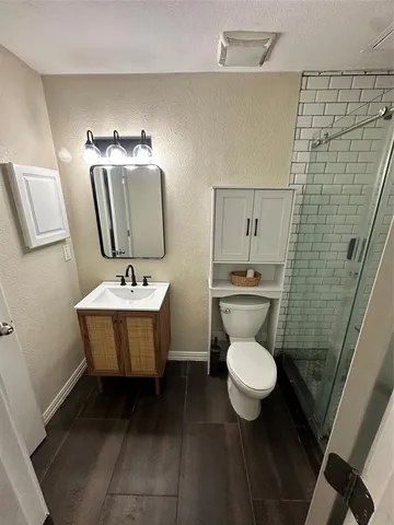 a bathroom with a sink toilet and a mirror