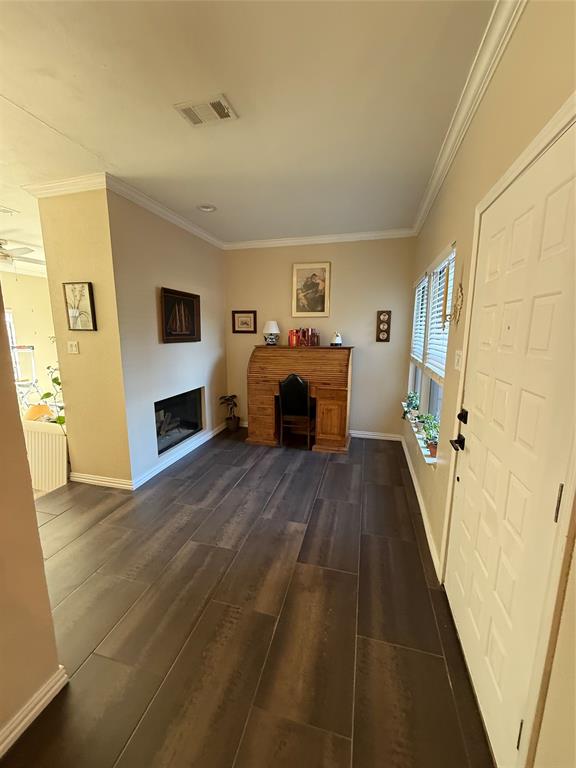 5616 Preston Oaks Road, Unit 1605 Dallas, TX 75254 - Photo 15 of 24 The entrance features a flex space and double sided fireplace. What a great space for a study, library or play!