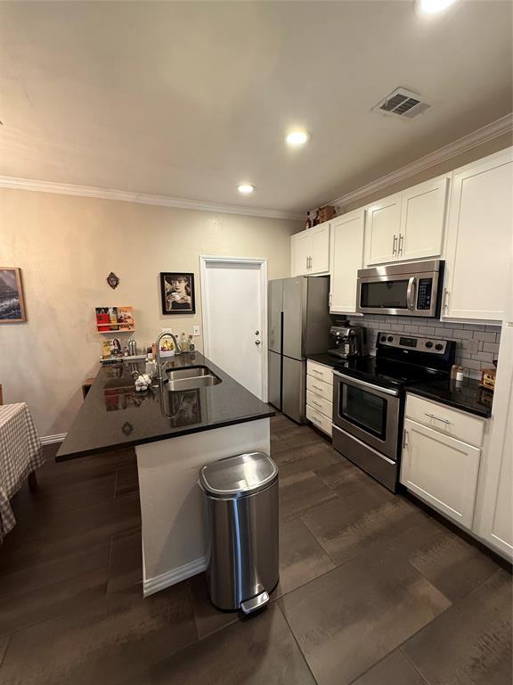 5616 Preston Oaks Road, Unit 1605 Dallas, TX 75254 - Photo 3 of 24 The island-breakfast bar has storage and room for casual meals.