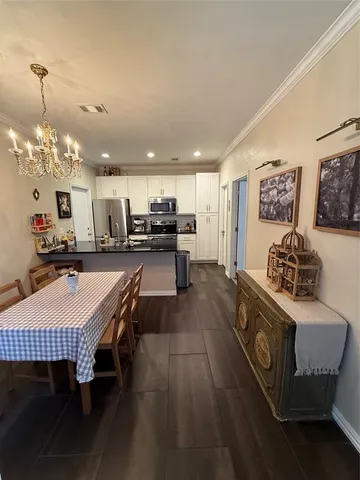 a large kitchen with a table and chairs