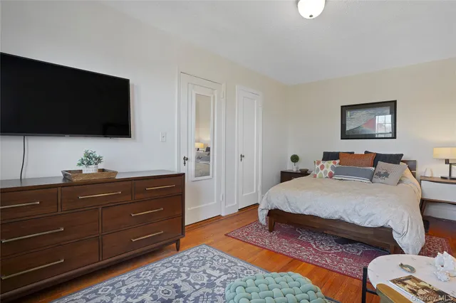 a bedroom with a bed and flat screen tv