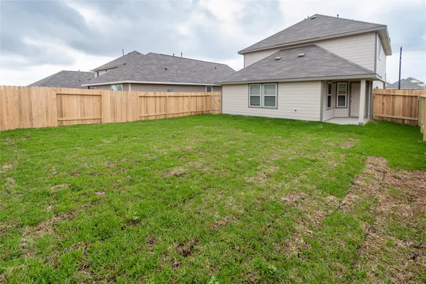 a view of a house with a yard and sitting area