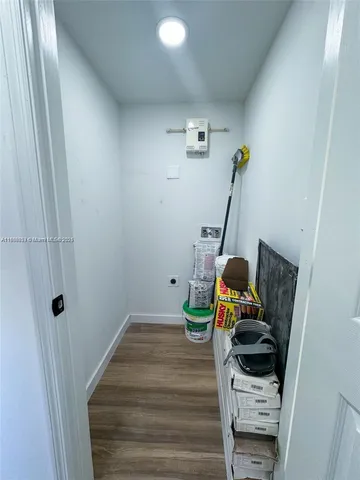 a living room with furniture a flat screen tv and a window