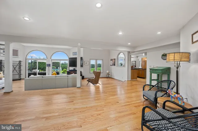 a living room with furniture a rug and kitchen view