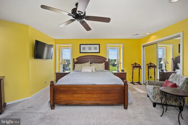 a bedroom with a bed and ceiling fan