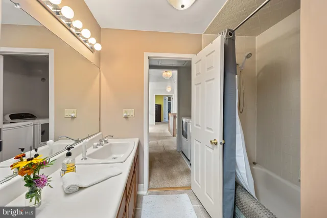 a bathroom with a sink mirror and shower