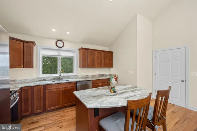 a kitchen with a stove a sink and a refrigerator