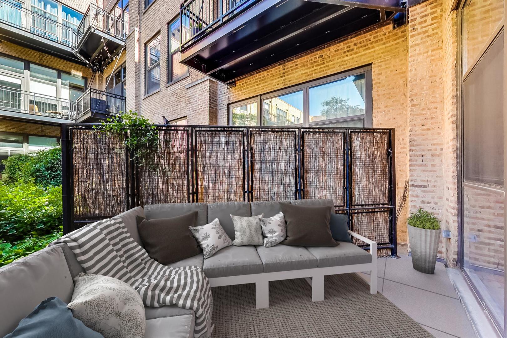 1040 West Adams Street, Unit 220 Chicago, IL 60607 - Photo 16 of 27 a balcony with furniture and a potted plant