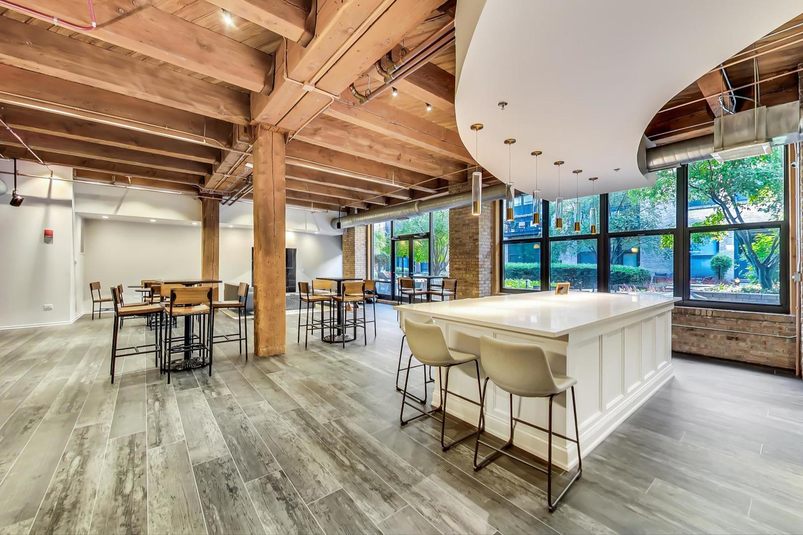 1040 West Adams Street, Unit 220 Chicago, IL 60607 - Photo 22 of 27 a spacious bathroom with a large window and a table