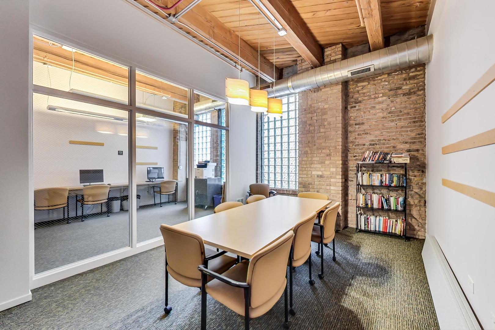 1040 West Adams Street, Unit 220 Chicago, IL 60607 - Photo 24 of 27 a dining room with a large window table and chairs