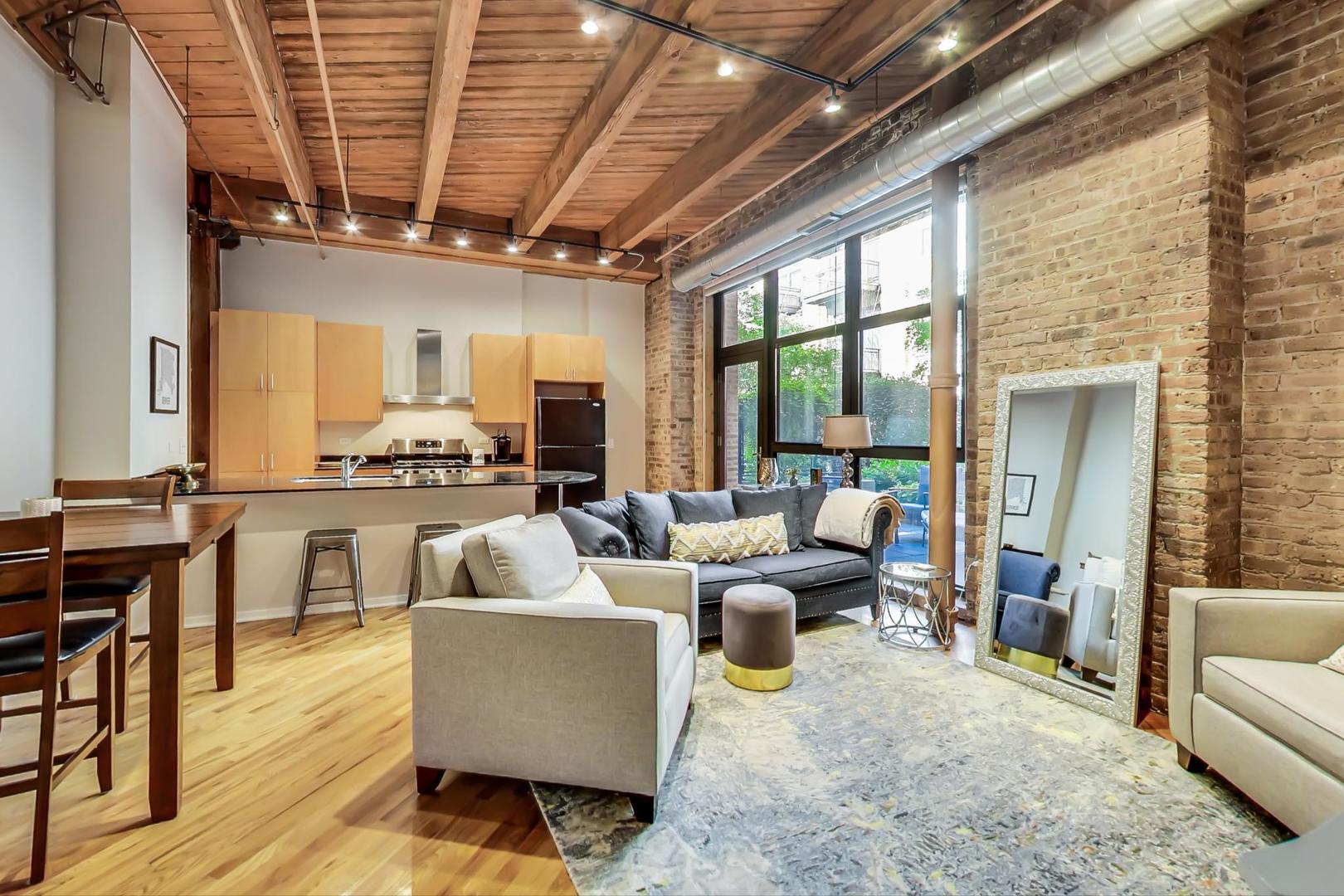 1040 West Adams Street, Unit 220 Chicago, IL 60607 - Photo 25 of 27 a living room with furniture and a large window