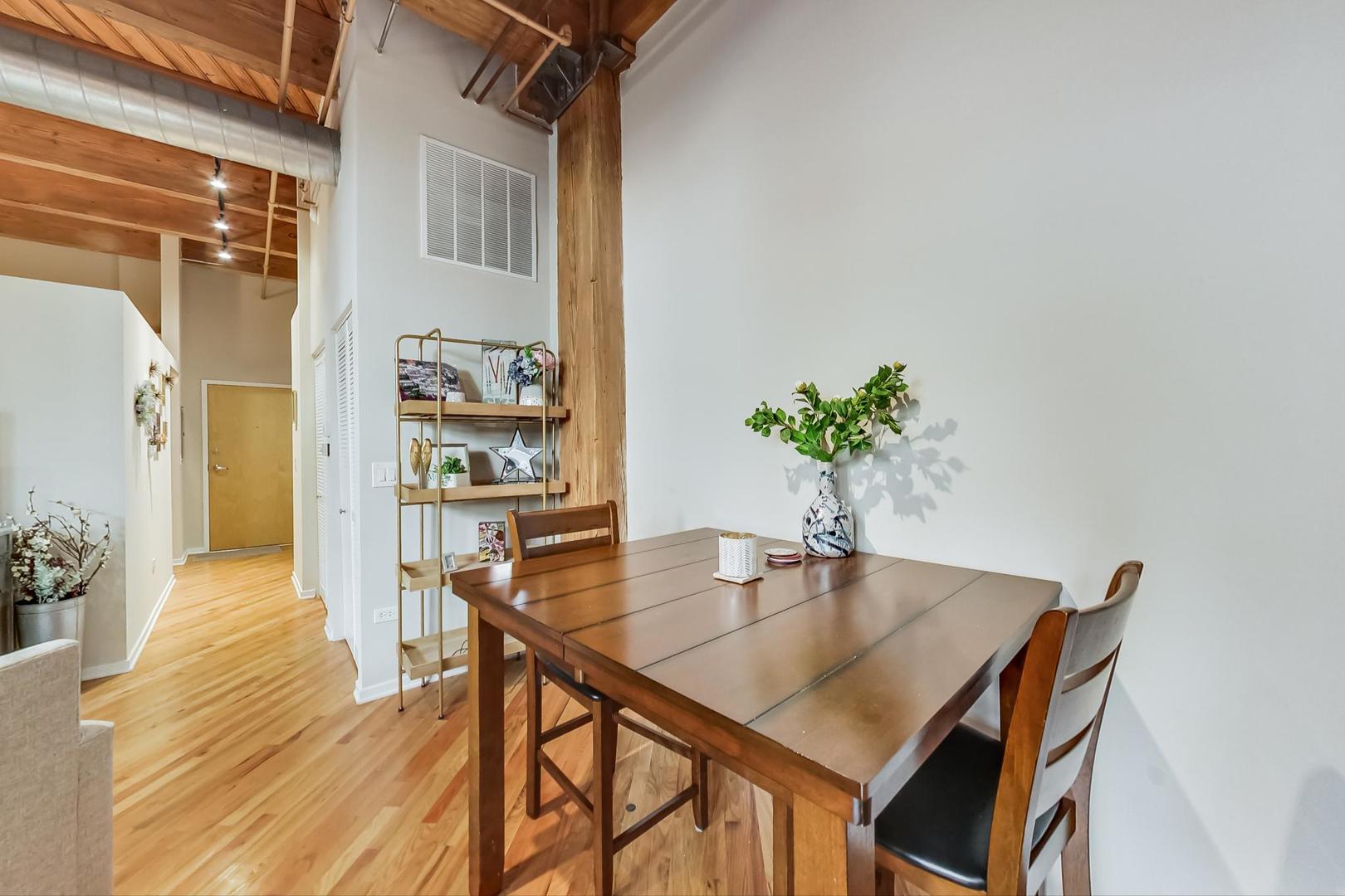 1040 West Adams Street, Unit 220 Chicago, IL 60607 - Photo 5 of 27 a dining room with furniture and wooden floor