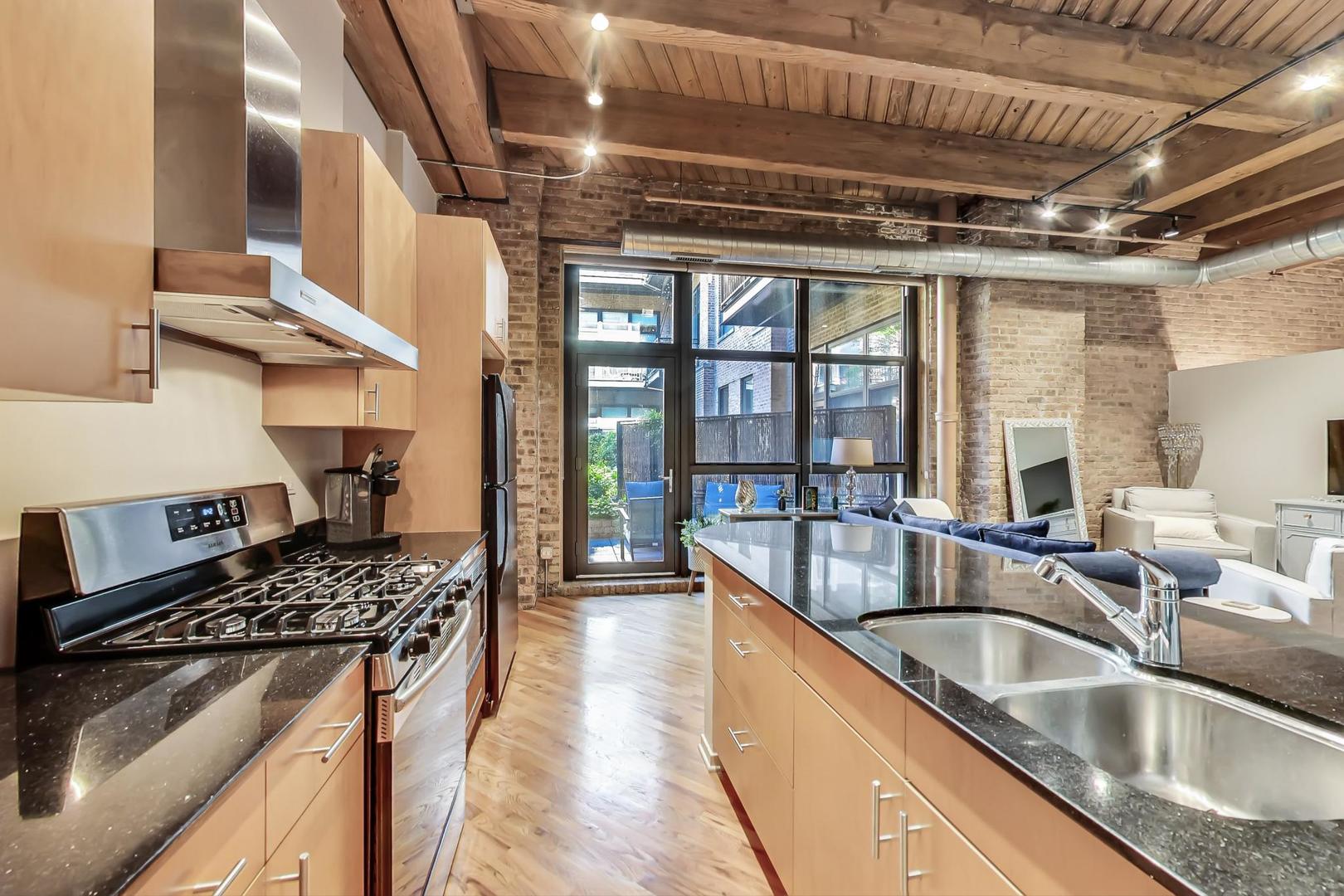 1040 West Adams Street, Unit 220 Chicago, IL 60607 - Photo 7 of 27 a kitchen that has a sink and a stove