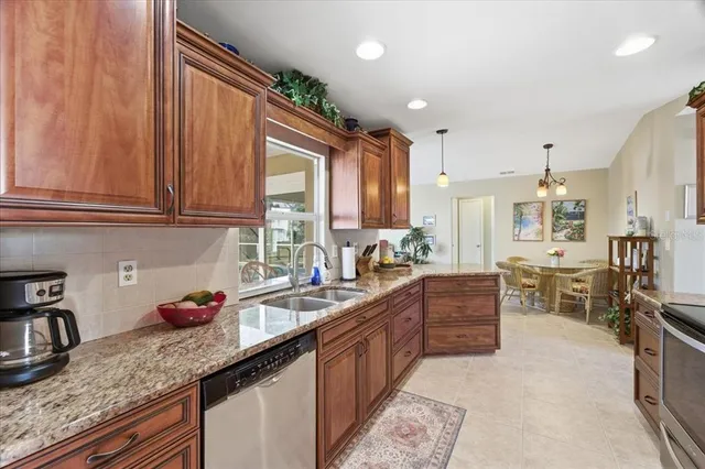 a kitchen with granite countertop a sink stove and cabinets
