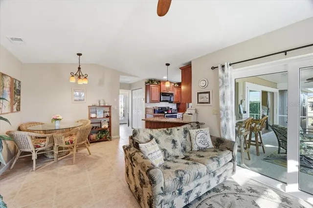 a living room with furniture a dining table and a piano table