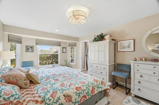 a bedroom with a large bed and a window