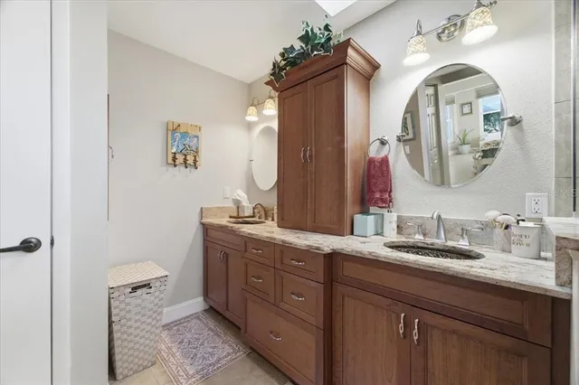 a bathroom with a double vanity sink and a mirror
