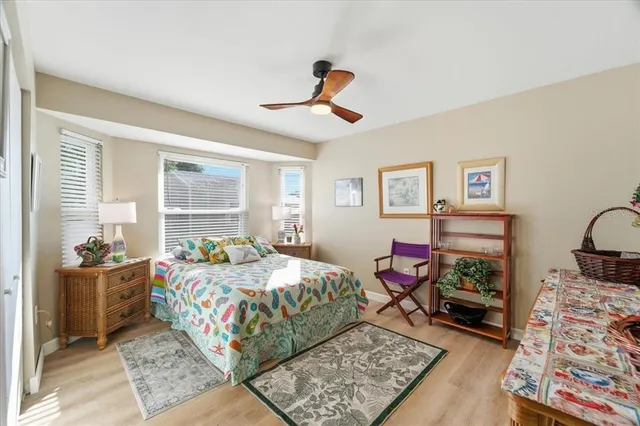 a bedroom with a bed a dresser and window