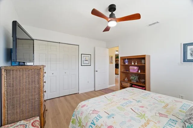 a bedroom with a bed and a mirror on the dresser