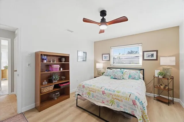 a bedroom with a bed and a painting on the wall