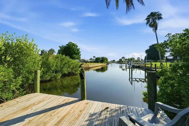 a balcony with wooden floor and lake view