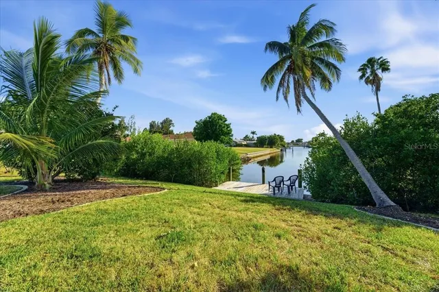 a swimming pool with outdoor seating and yard