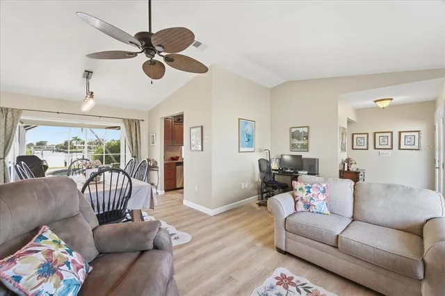 a living room with furniture ceiling fan and a rug