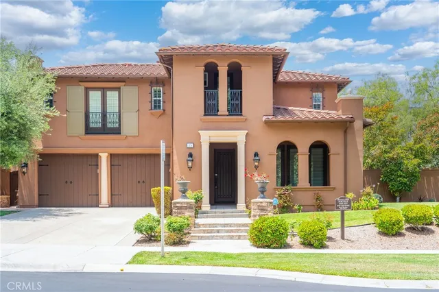 a front view of a house with a yard garage and outdoor seating