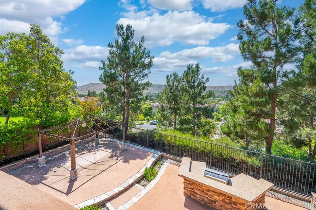 a dining room with furniture a potted plant and wooden floor