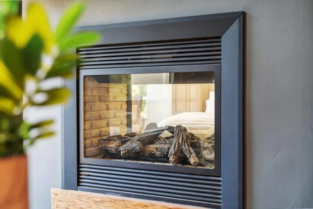 a bedroom with a large bed and wooden floor