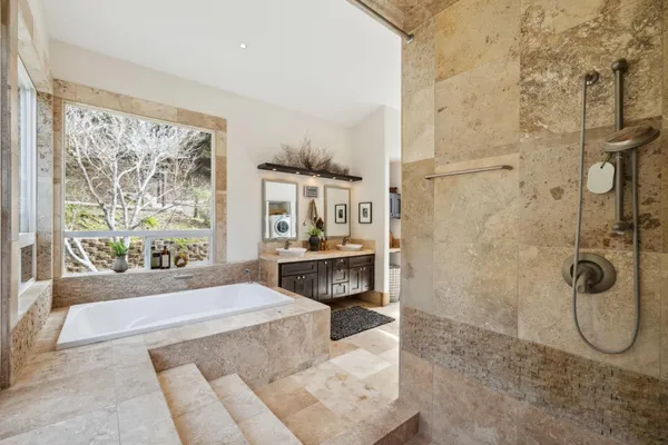 a bedroom with a large bed and wooden floor