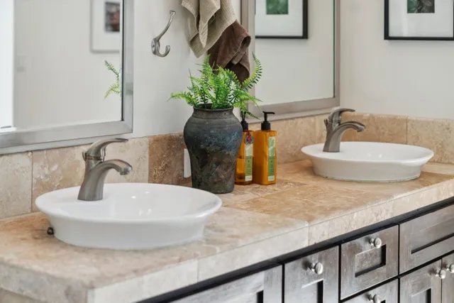 a bathroom with a granite countertop sink a toilet and shower