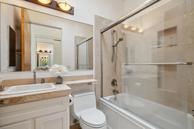a dining hall with stainless steel appliances granite countertop a sink and wooden floor