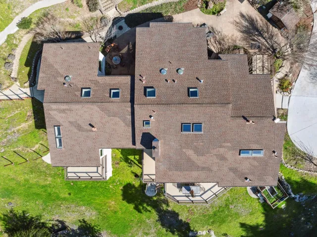 an aerial view of a house with a backyard