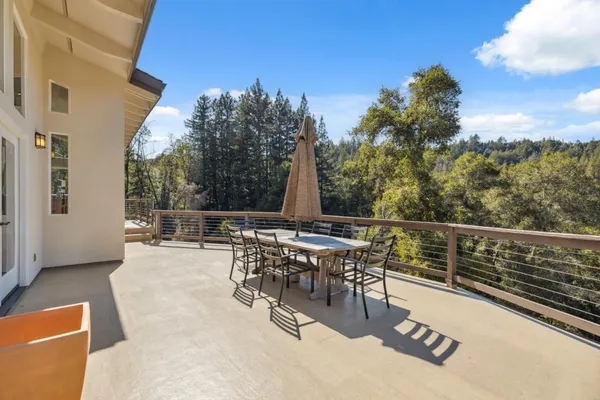 a view of a patio with a table and chairs