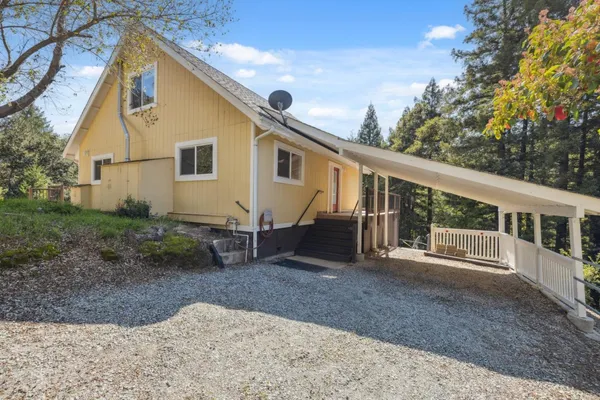 an aerial view of a house with a backyard