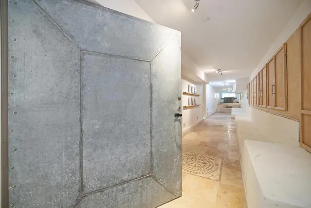 a front view of a house with a tree