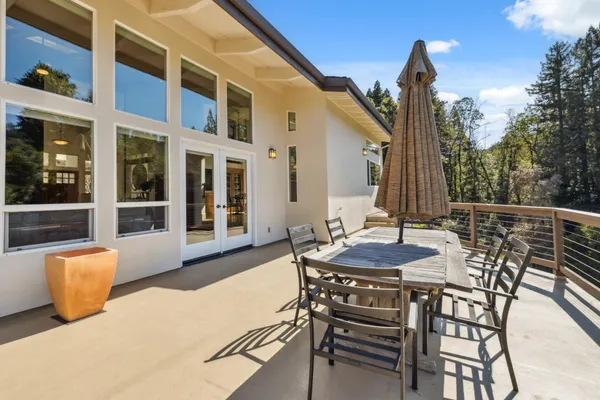 a view of a patio with table and chairs