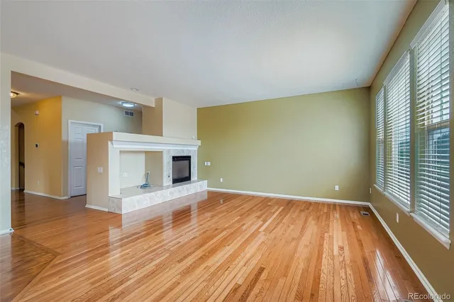 a view of a room with wooden floor and fireplace